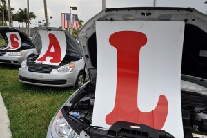 cars displaying letters at car dealership